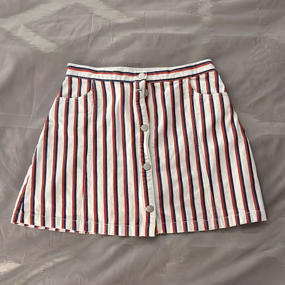 White button down skirt with blue and red stripes. Has pockets.